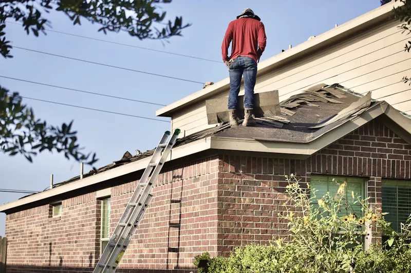 Professional roofer working on a residential roof in El Monte